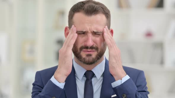 Portrait of Tired Businessman Having Headache