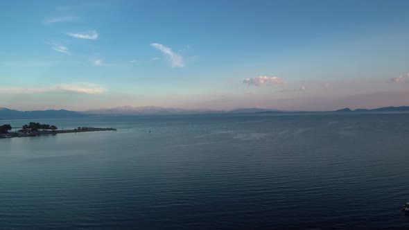 Sunset in Mesologgi Greece. Aerial view of the sunset behind clouds and sea horizon.