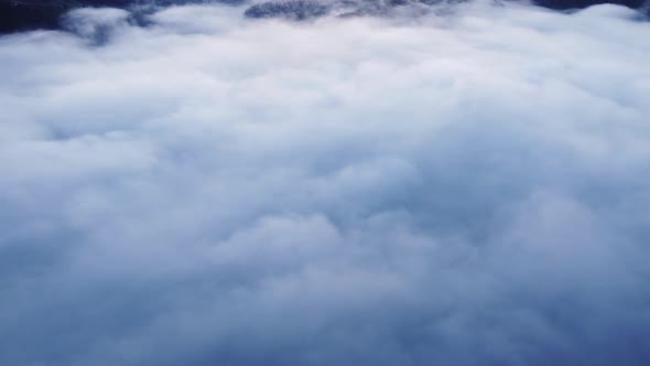 Aerial View From Above of Inverted Clouds in the Light of the Morning Sun Beautiful Foggy Landscape