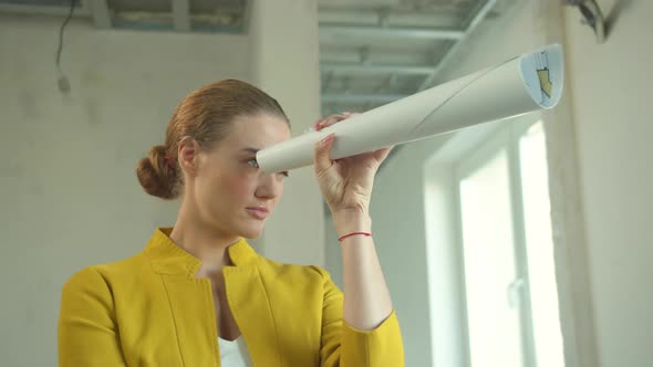 Woman Stands and Looks Through the Drawing