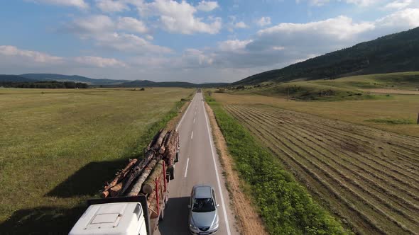 Flying Fast FPV Drone Along the Country Road on a Beautiful Sunny Day on a Green Meadow Close to the