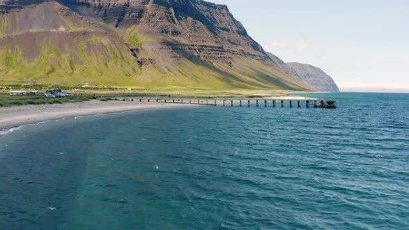 Drone Flying Towards Jetty At The Beach At Westfjord With Mountain Views At Daytime In Iceland. - ae