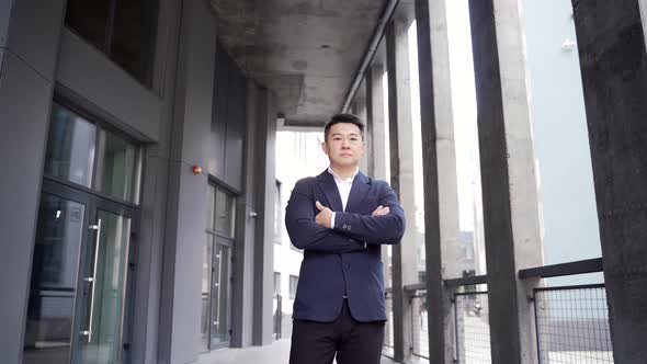 portrait young confident successful asian businessman looking at camera