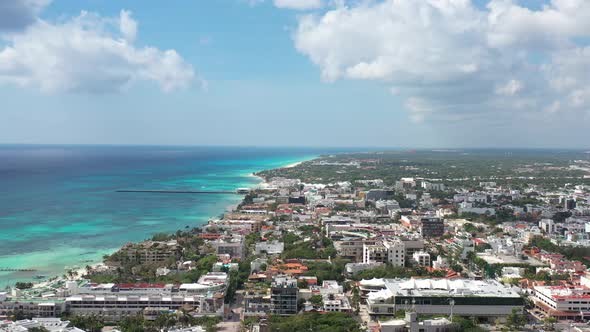 Caribbean city aerial shot, high altitude lateral tracking heading inland