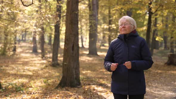 Active Senior Female Jogger Doing Sports in Park