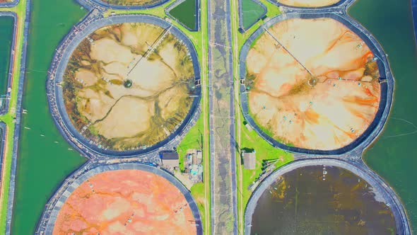An aerial view of a drone flying over a large shrimp farm