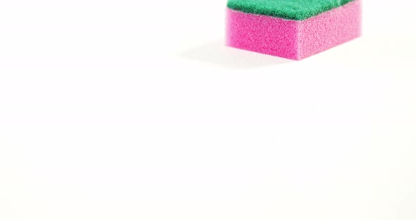 Plastic cleaning sponge falling on white background