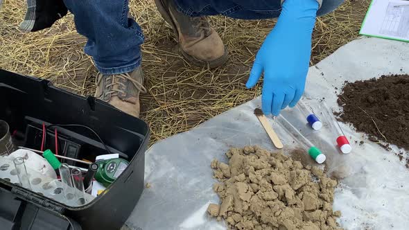Closeup Scientist Preparing for Measuring Soil pH Value By Soil Tester