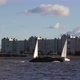 Yacht Sailboats Sailing Against the Background of the City and Residential Buildings - VideoHive Item for Sale