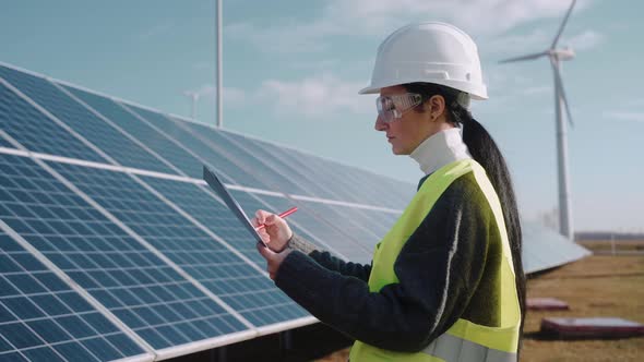 Close Up of Female Ecological Engineer Checking the Operation of Solar Panels