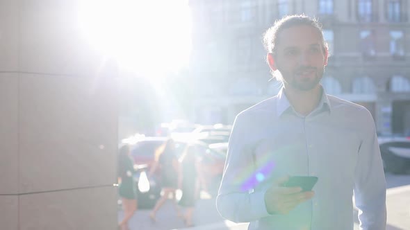 Business Man Using Mobile Phone On Street On Sunny Day