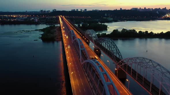 Aerial Perspective View of a Cityscape with Illuminated Bridge Above the River
