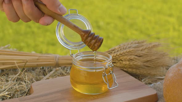 Hand Taking Honey with Honey Spoon