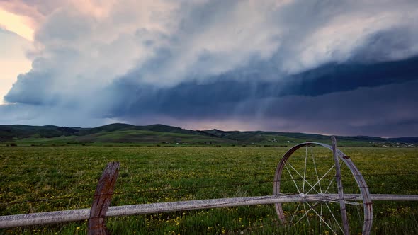 Time lapse of thunder storm rolling through the sky over field