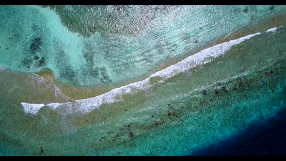 Aerial drone view nature of perfect shore beach vacation by blue green water with white sandy backgr