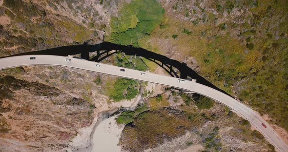 Top View Drone Rising and Spinning Above Bixby Creek Bridge in Big Sur with Traffic