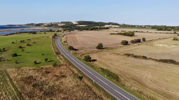 Aerial view of the coastline of Sejerøbugten with Vejrhøj, fields and ocean.