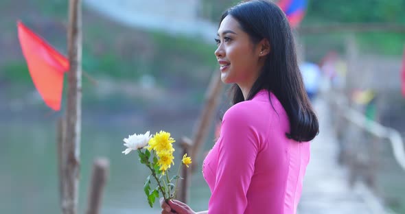 Vietnamese Woman In “Ao Dai” Traditional Dress Of Vietnam On Bamboo Bridge