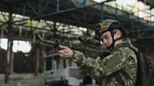 Military Woman Looking Through Sight of Rifle