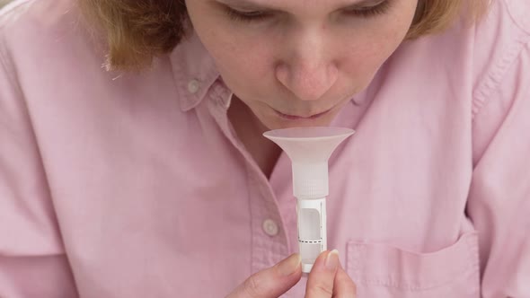 a Woman Collects Saliva in a Container for a Dna Test