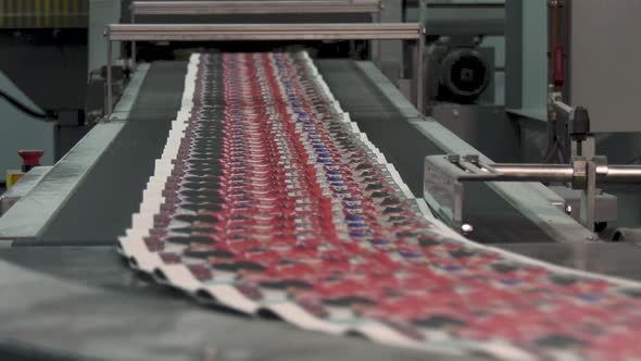 Printed newspapers moving on conveyor at high speed in printing factory