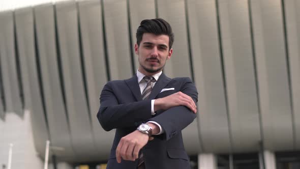 Businessman looking at his watch and smiling