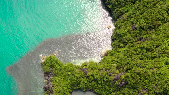 Rocky Island with a Jungle and a Turquoise Lagoon, Aerial View. Caramoan Islands, Philippines.