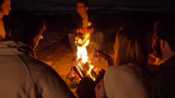 Friends Roasting Marshmallow on Fire on Beach