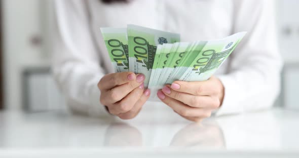 Business Person Counts One Hundred Euro Banknotes Closeup