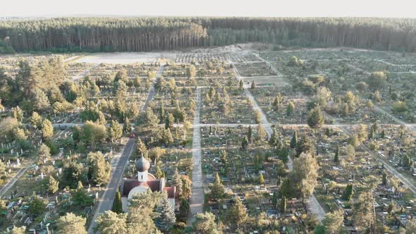 Cemetery with graves. Drone flying over old cemetery at sunrise.