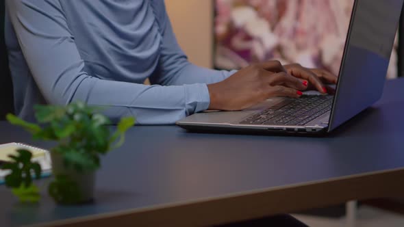 Close Up of African Woman Typing on Laptop