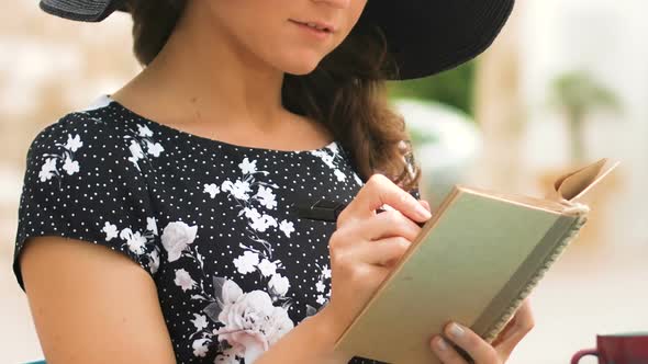 Close-Up of Pretty Female Writer Making Notes in Notebook, Young Journalist