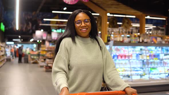 Smiling Girl While Shopping in the Supermarket