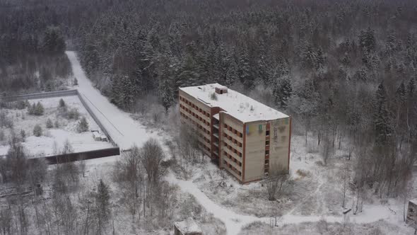 an Abandoned Multistorey Building From the Times of the USSR in a Dense Forest in a Winter Landscape