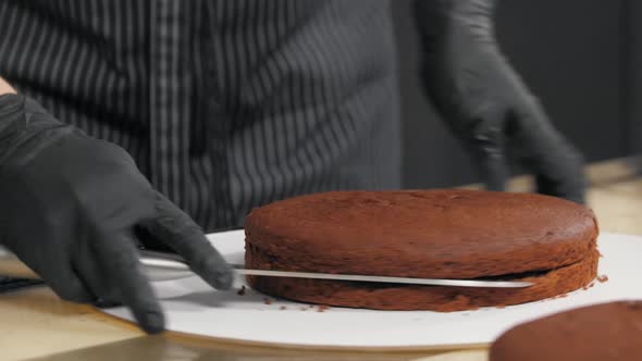 Cuts Chocolate Sponge Cake on the Table