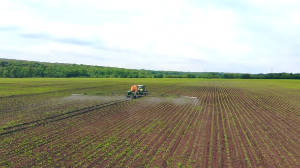 Aerial View Farm Machinery Spraying Insecticide To the Green Field, Agricultural Natural Seasonal