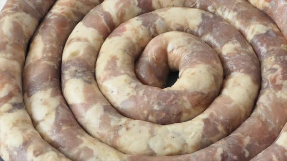 Raw Homemade Sausage Lies on the Cutting Board