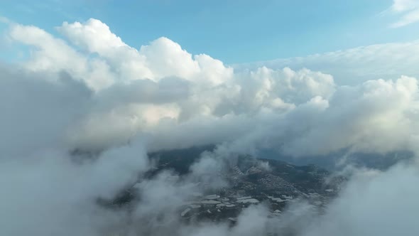 Over the city in the clouds aerial view 4 K