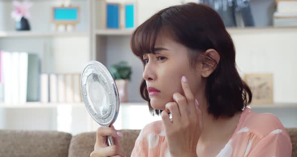 Portrait asian young woman find acne on her cheek