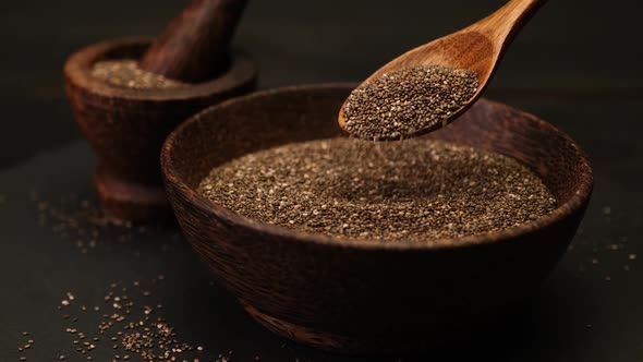 Organic Natural Chia Seeds in Wooden Bowl Closeup on Dark Wooden Background or Table
