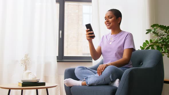 African American Woman with Smartphone at Home