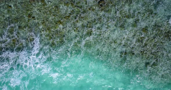 Luxury flying copy space shot of a sunshine white sandy paradise beach and aqua blue ocean background