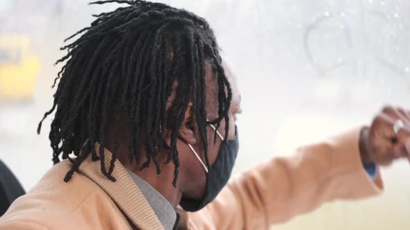 African American Student in Mask Using Public Transport