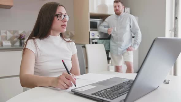 Adult Caucasian Couple at Home in Smart Working and Remote Work Job Activity Sitting at the Desk in