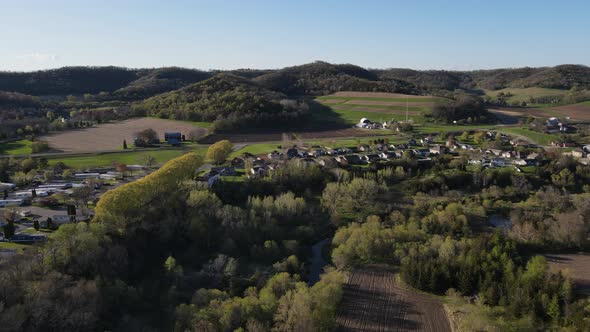 View of midwest Wisconsin valley, mountains, forest, farm fields, and residential homes.