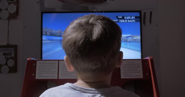 Child playing racing game simulator