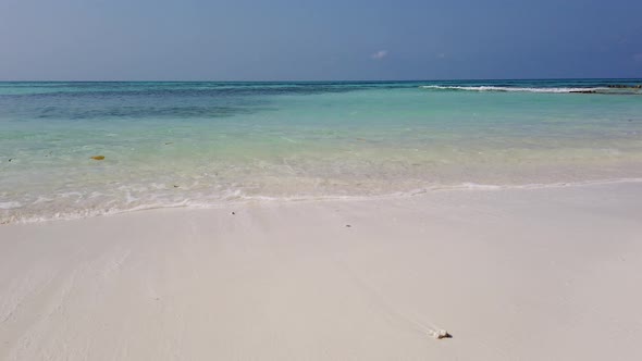 Wide angle overhead copy space shot of a white sand paradise beach and blue sea background in colorf