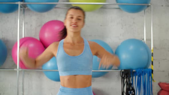 Woman Fitness Coach Doing Slope Exercise in Gym Club. Sporty Woman Training Stretching Slope with