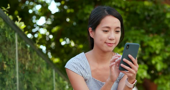 Woman Use of Mobile Phone at Outdoor