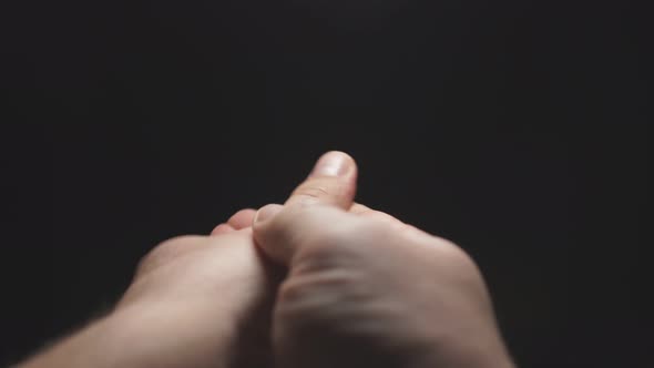 Close-up of a Man's Hand on a Black Background, a Man's Hand Sprays Disinfectant on the Palm and